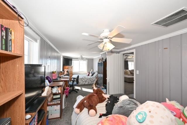 carpeted bedroom with multiple windows, crown molding, and ceiling fan