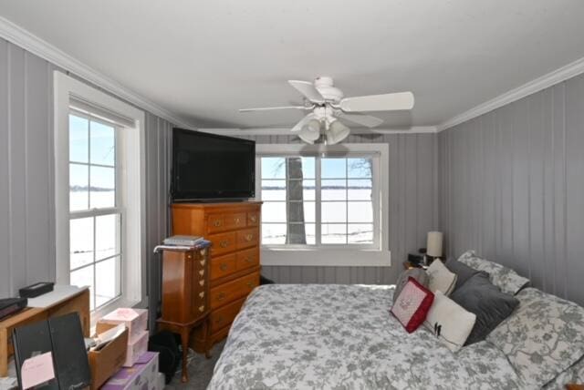 bedroom with ceiling fan and crown molding
