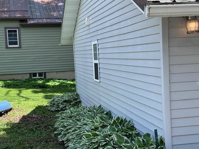view of side of home with a lawn