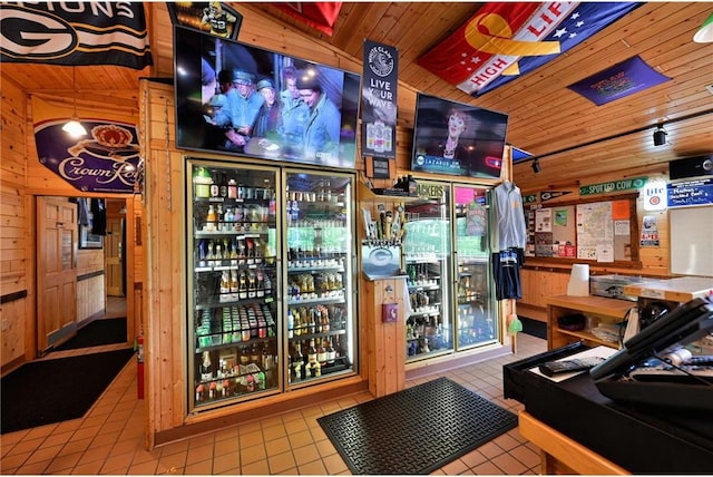 interior space featuring tile patterned floors, lofted ceiling, wood walls, and wood ceiling