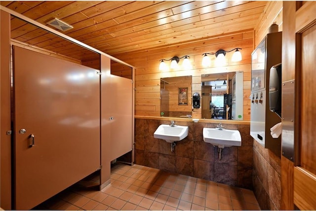 bathroom with tile patterned floors, wood walls, and wood ceiling