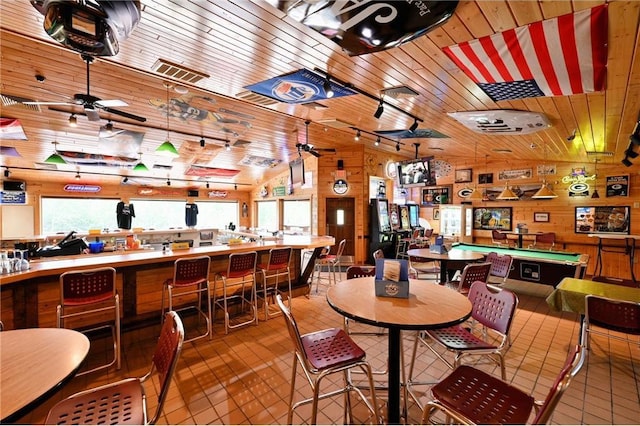 tiled dining space featuring lofted ceiling, billiards, wooden walls, ceiling fan, and wood ceiling