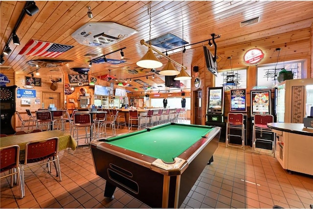 playroom with wood walls, light tile patterned floors, track lighting, and pool table