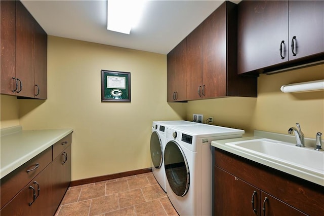 washroom featuring cabinets, washer and dryer, and sink