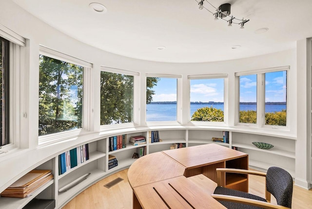 sunroom / solarium with a water view