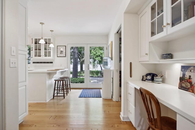 interior space with built in desk and light hardwood / wood-style floors