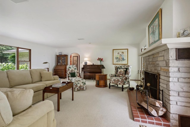 carpeted living room with a brick fireplace