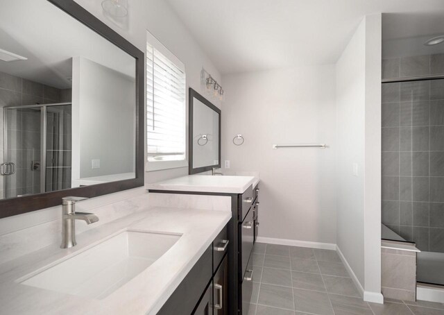 bathroom with tile patterned flooring, vanity, and a shower with door