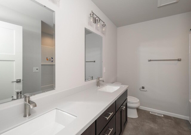 bathroom featuring vanity and toilet