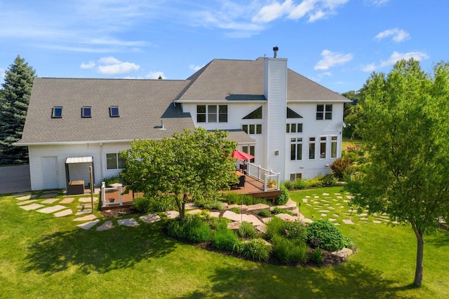 back of house featuring a lawn and a wooden deck