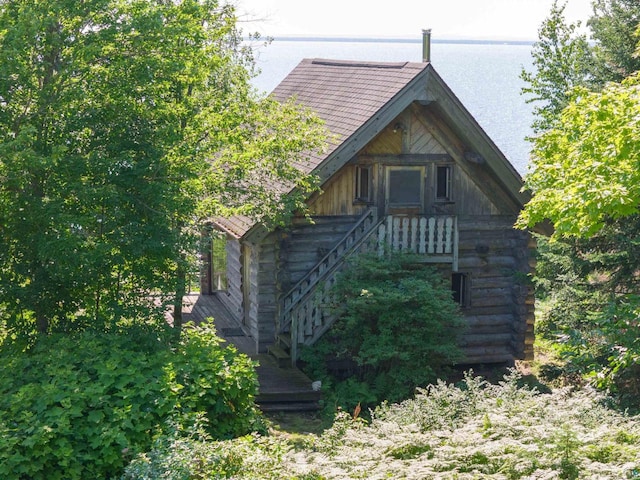 view of property exterior featuring a water view