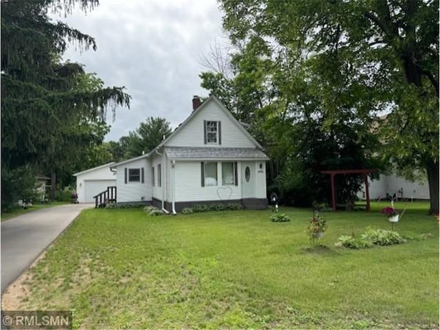 view of front of house with a garage and a front lawn