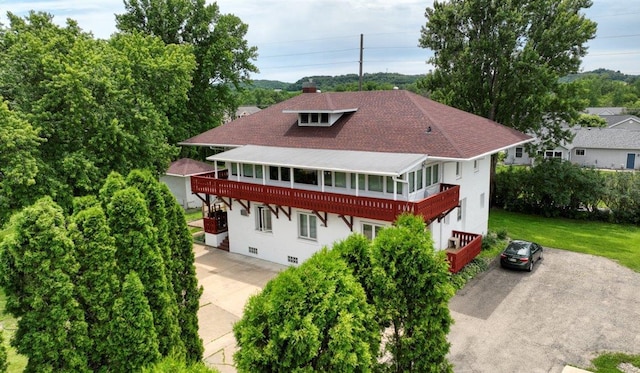 view of front of property with a front lawn and a sunroom