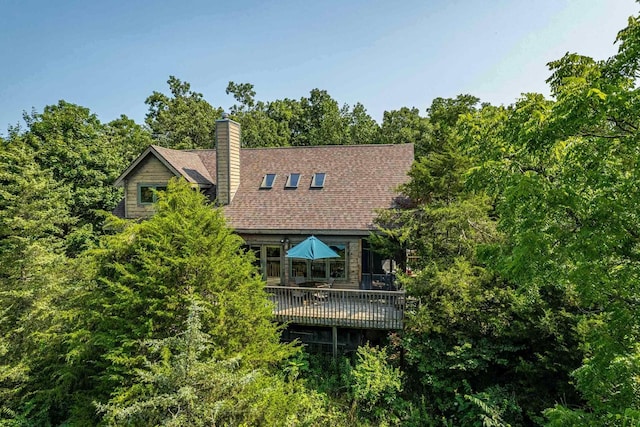 back of property with a wooden deck