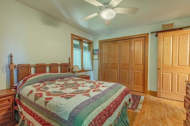 bedroom featuring light hardwood / wood-style floors, a closet, and ceiling fan