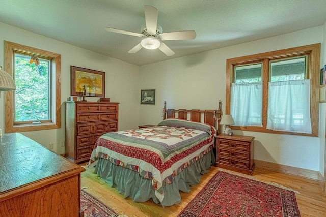 bedroom featuring ceiling fan and light hardwood / wood-style flooring