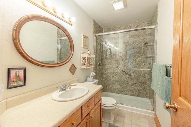 bathroom featuring vanity, toilet, and an enclosed shower