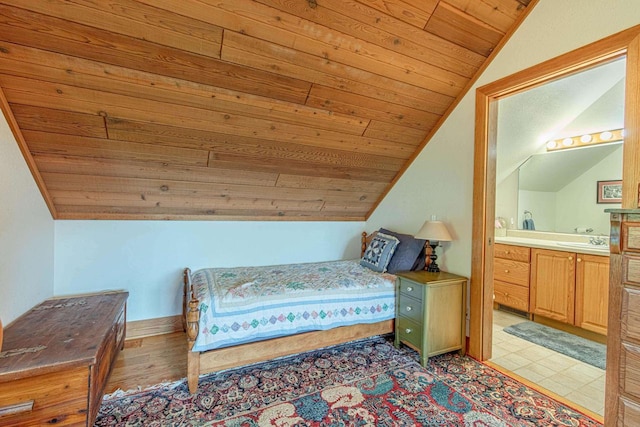 bedroom with ensuite bath, lofted ceiling, sink, and wooden ceiling