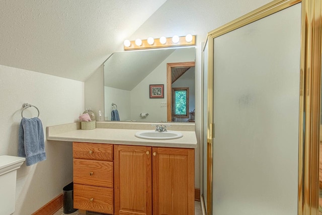 bathroom with walk in shower, lofted ceiling, vanity, and a textured ceiling