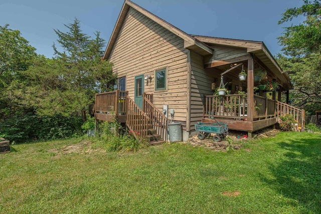 view of side of property featuring a yard and a deck