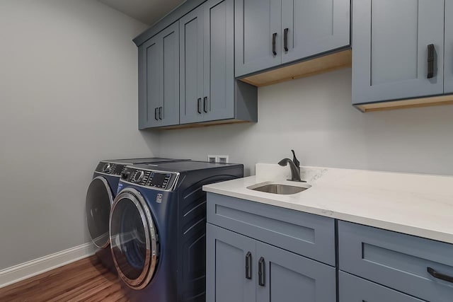 1421 Greenleaf Ct, Sun Prairie, WI 53590 - washroom with cabinet space, washer and clothes dryer, baseboards, and dark wood-type flooring