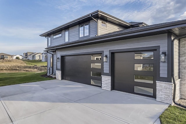 1421 Greenleaf Ct, Sun Prairie, WI 53590 - view of front of home featuring concrete driveway, stone siding, a front lawn, and a garage