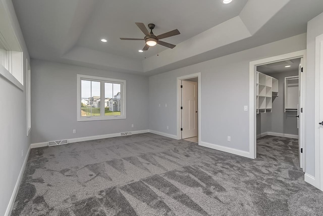 1421 Greenleaf Ct, Sun Prairie, WI 53590 - unfurnished bedroom with a raised ceiling, carpet floors, baseboards, a spacious closet, and recessed lighting