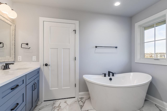 1421 Greenleaf Ct, Sun Prairie, WI 53590 - bathroom with marble finish floors, baseboards, a freestanding tub, and recessed lighting