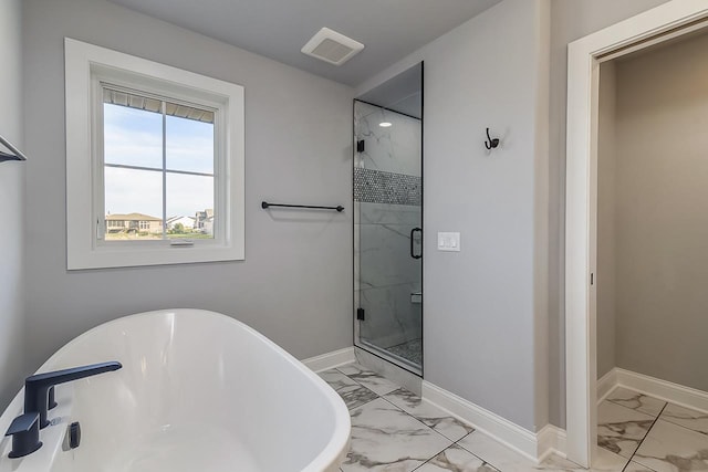 1421 Greenleaf Ct, Sun Prairie, WI 53590 - full bathroom with marble look tiles, a freestanding tub, a stall shower, and baseboards