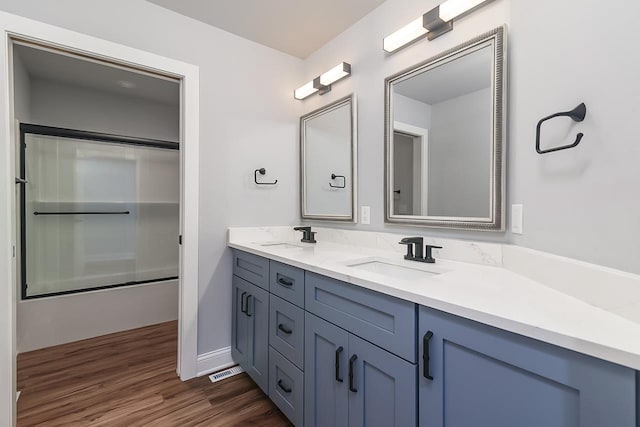 1421 Greenleaf Ct, Sun Prairie, WI 53590 - full bathroom featuring wood finished floors, double vanity, shower / tub combination, and baseboards