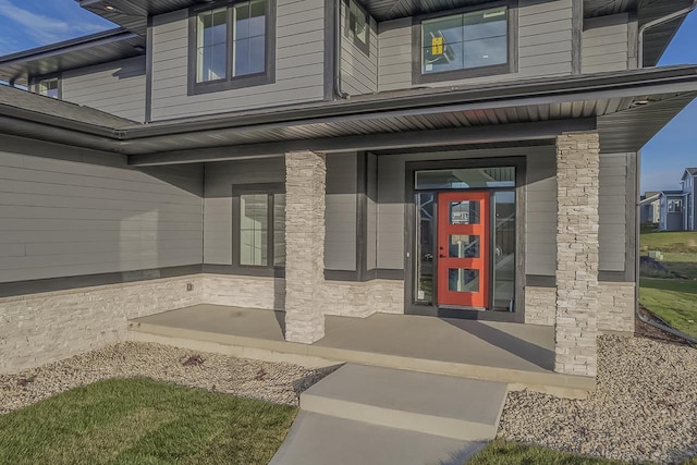 1421 Greenleaf Ct, Sun Prairie, WI 53590 - view of exterior entry with stone siding and a porch