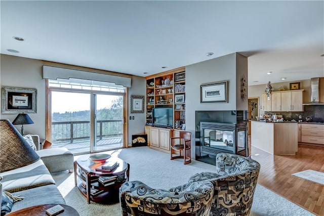 living room featuring a tile fireplace