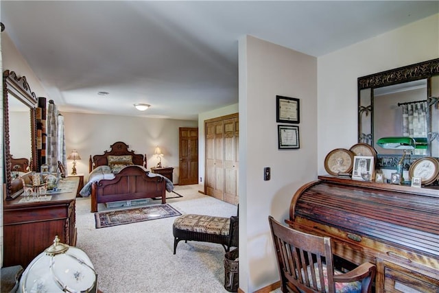 bedroom featuring light colored carpet and a closet