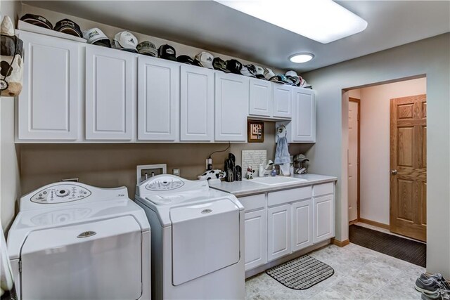 177 Monte Carlo Dr, Eau Claire, WI 54703 - laundry room with a sink, cabinet space, independent washer and dryer, and baseboards