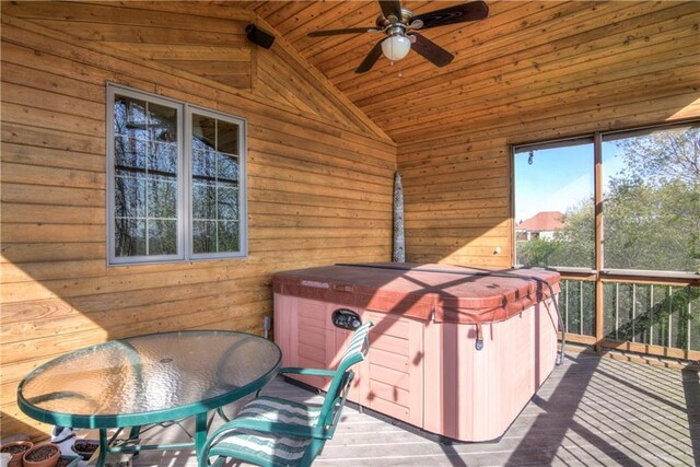 wooden terrace featuring ceiling fan and a hot tub