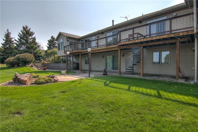 back of house with a yard, a deck, and a patio area