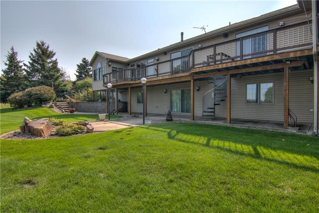 177 Monte Carlo Dr, Eau Claire, WI 54703 - rear view of house with a wooden deck, a patio area, stairway, and a yard