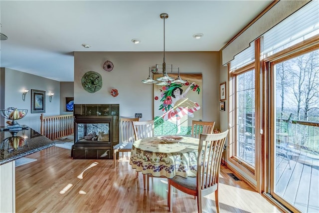 dining room featuring light hardwood / wood-style floors and a fireplace