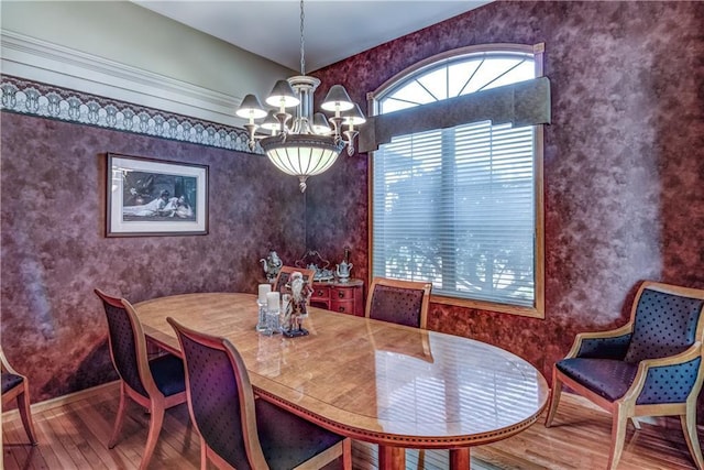 dining area featuring wood-type flooring and an inviting chandelier