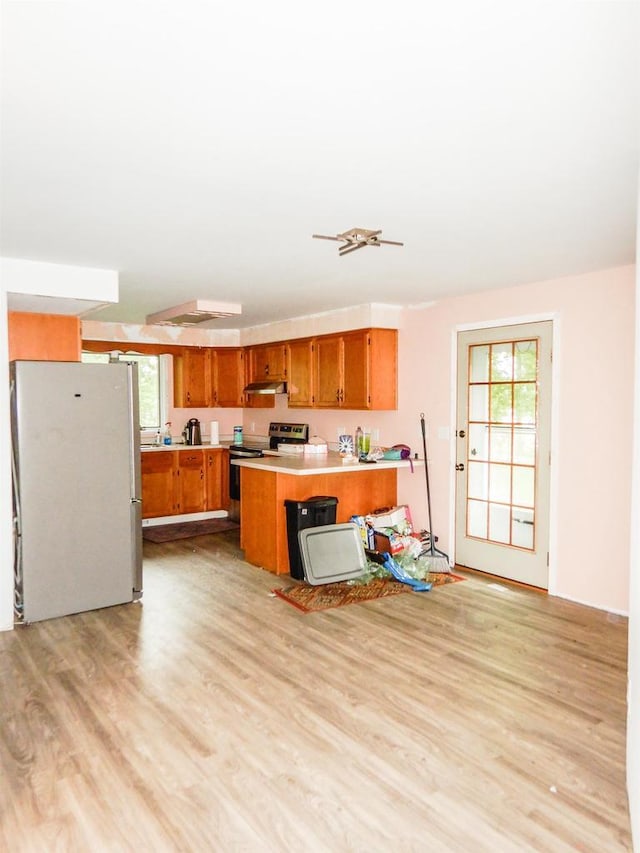 441 Washington St, Oconto, WI 54153 - kitchen featuring a center island, light wood-type flooring, white fridge, and stainless steel electric range oven