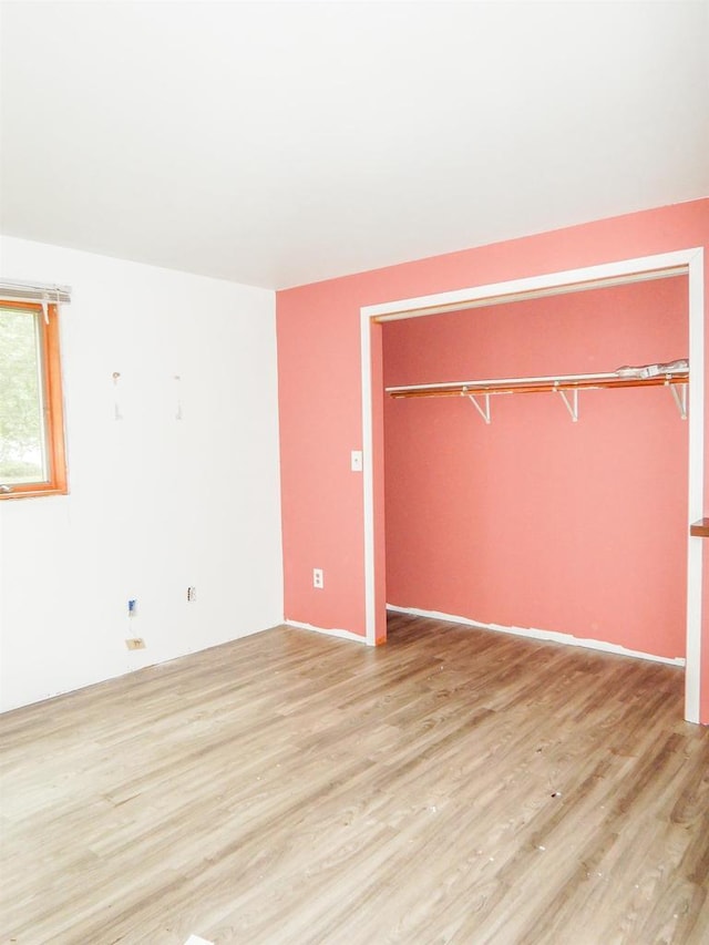 441 Washington St, Oconto, WI 54153 - unfurnished bedroom with light hardwood / wood-style floors and a closet