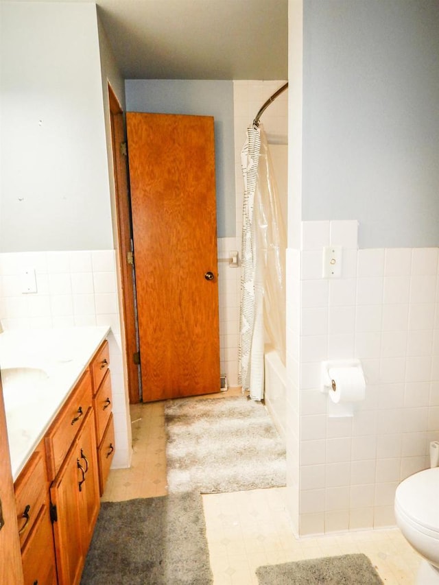 441 Washington St, Oconto, WI 54153 - full bathroom featuring tile patterned flooring, toilet, shower / tub combo with curtain, vanity, and tile walls