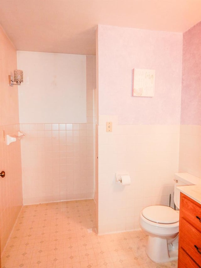 441 Washington St, Oconto, WI 54153 - bathroom featuring vanity, tile walls, and toilet