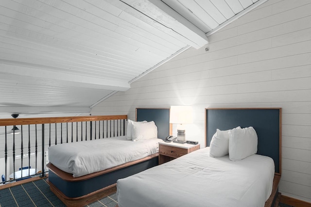 bedroom featuring vaulted ceiling with beams