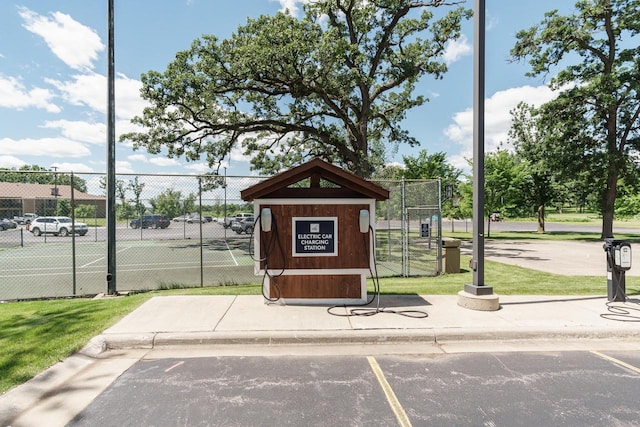 view of property's community featuring tennis court