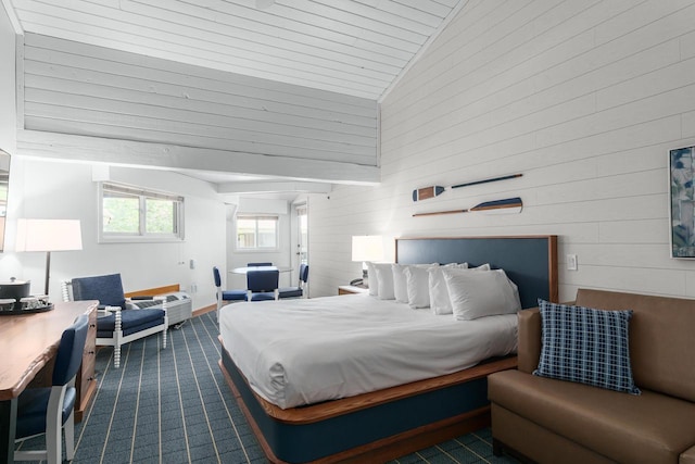 bedroom featuring high vaulted ceiling and wooden walls