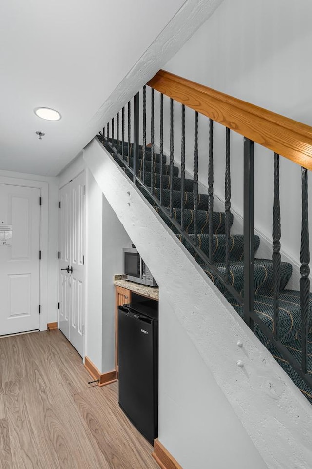 stairs with hardwood / wood-style floors