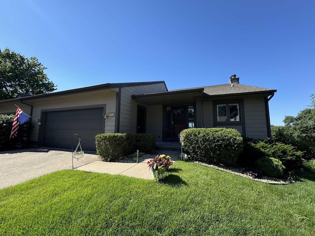 ranch-style house with a garage and a front yard