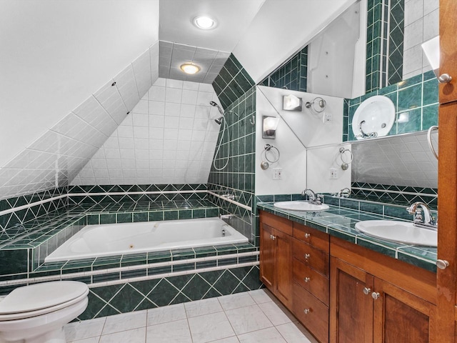 full bathroom with tile patterned floors, toilet, vanity, tile walls, and tiled shower / bath