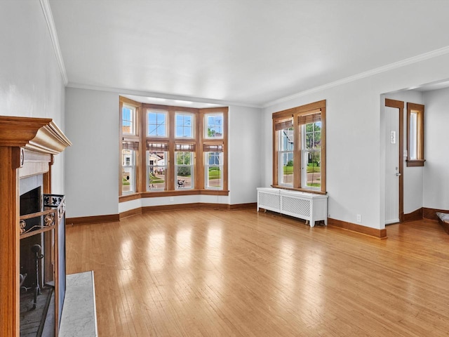 unfurnished living room featuring radiator heating unit, a high end fireplace, and ornamental molding